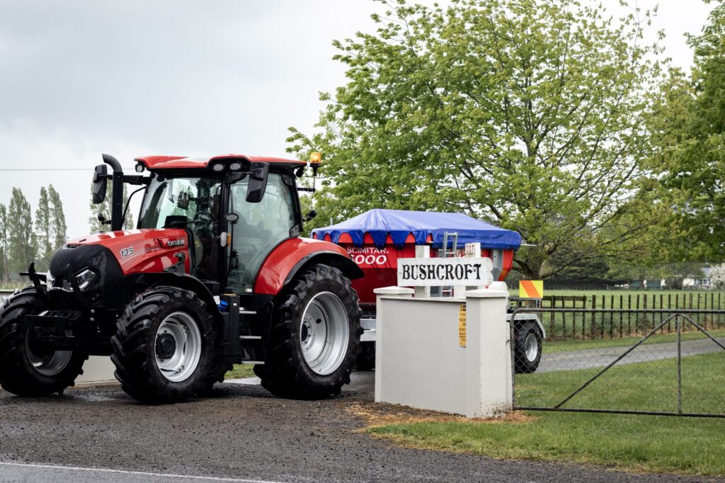 Scimitar 6000 spreader and tractor at a farm entrance